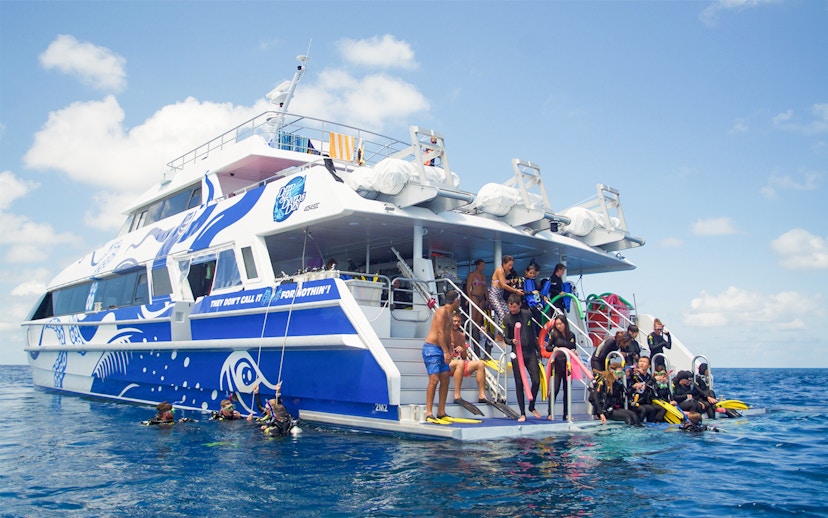 Tourists preparing to dive from a boat on the Outer Great Barrier Reef trip from Cairns.