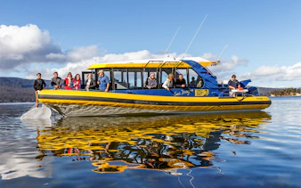 Tourists enjoying a boat ride on the Tasmanian Seafood Seduction tour.