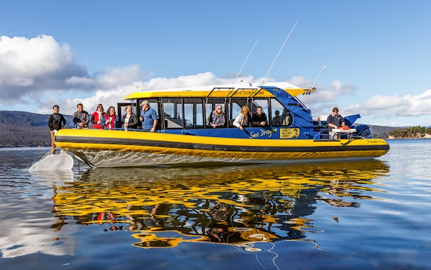 Tourists enjoying a boat ride on the Tasmanian Seafood Seduction tour.
