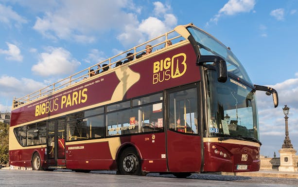 Open-top tour bus in Paris for evening city and Eiffel Tower tour.