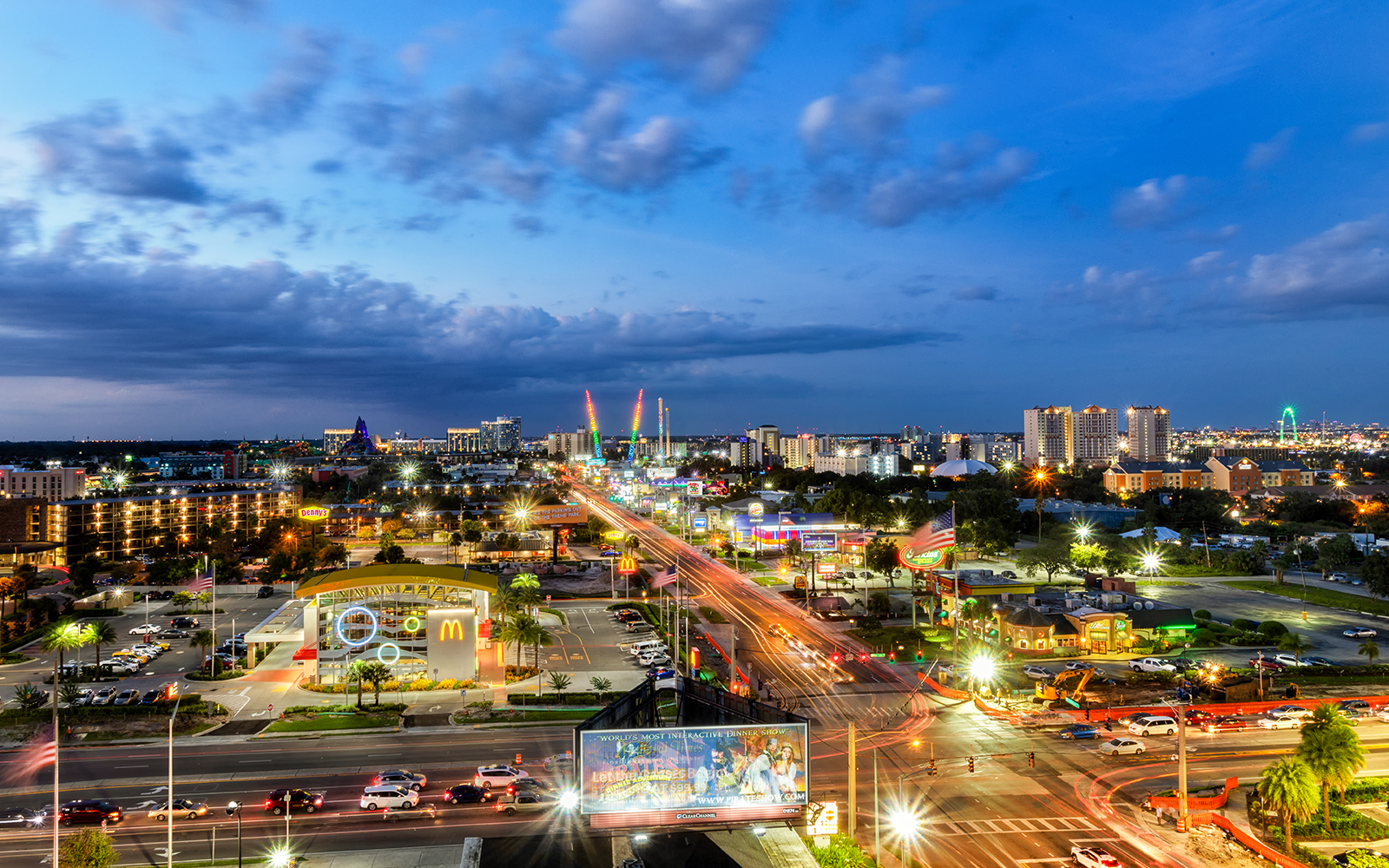 Cityscape view of Niagara Falls, Canada, illuminated at dusk with vibrant lights and bustling streets.