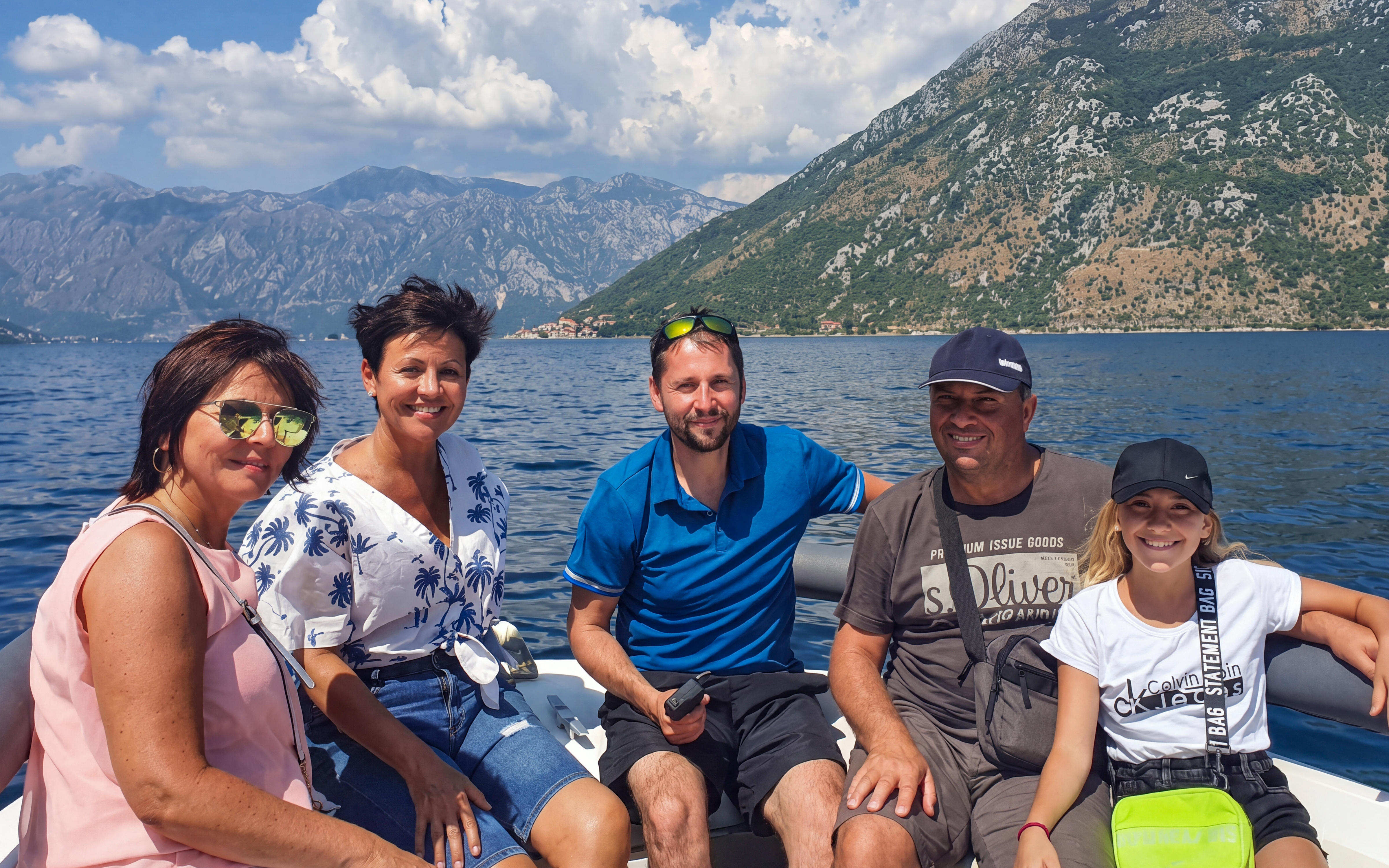 Group enjoying boat ride near Lady of the Rocks and Perast Old Town, Montenegro.