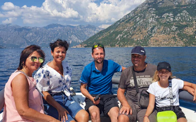 Group enjoying boat ride near Lady of the Rocks and Perast Old Town, Montenegro.