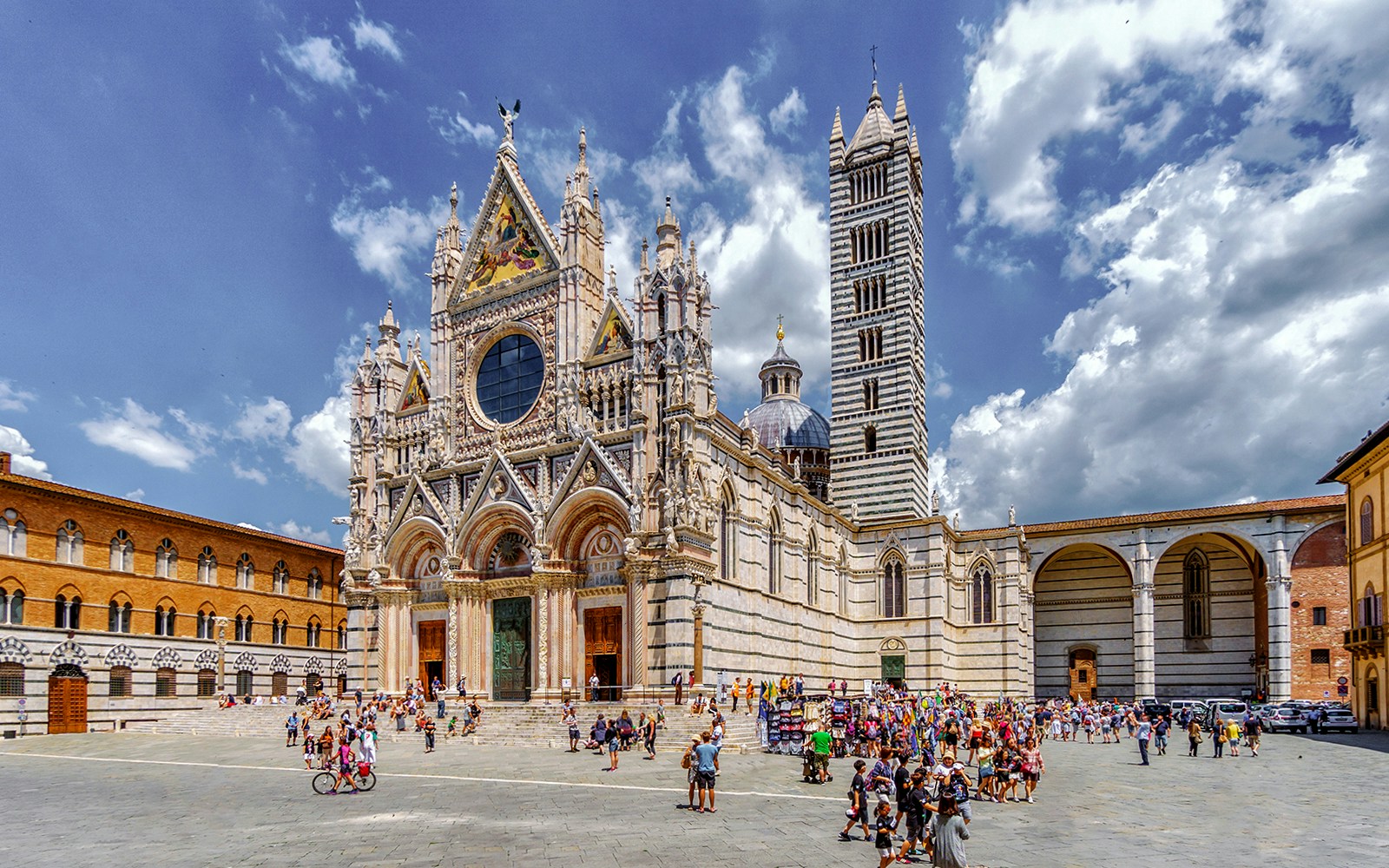 Siena Cathedral with tourists in the square, part of San Gimignano, Siena, Monteriggioni, Chianti day trip.