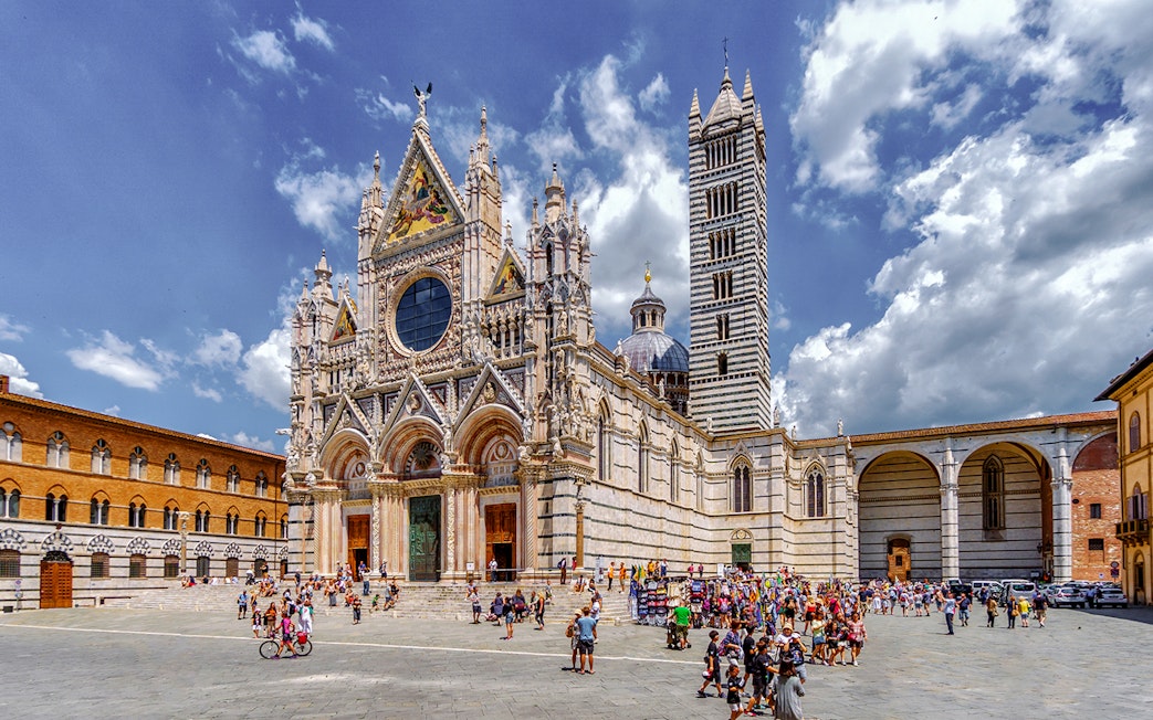 Siena Cathedral with tourists in the square, part of San Gimignano, Siena, Monteriggioni, Chianti day trip.