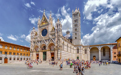 Siena Cathedral with tourists in the square, part of San Gimignano, Siena, Monteriggioni, Chianti day trip.
