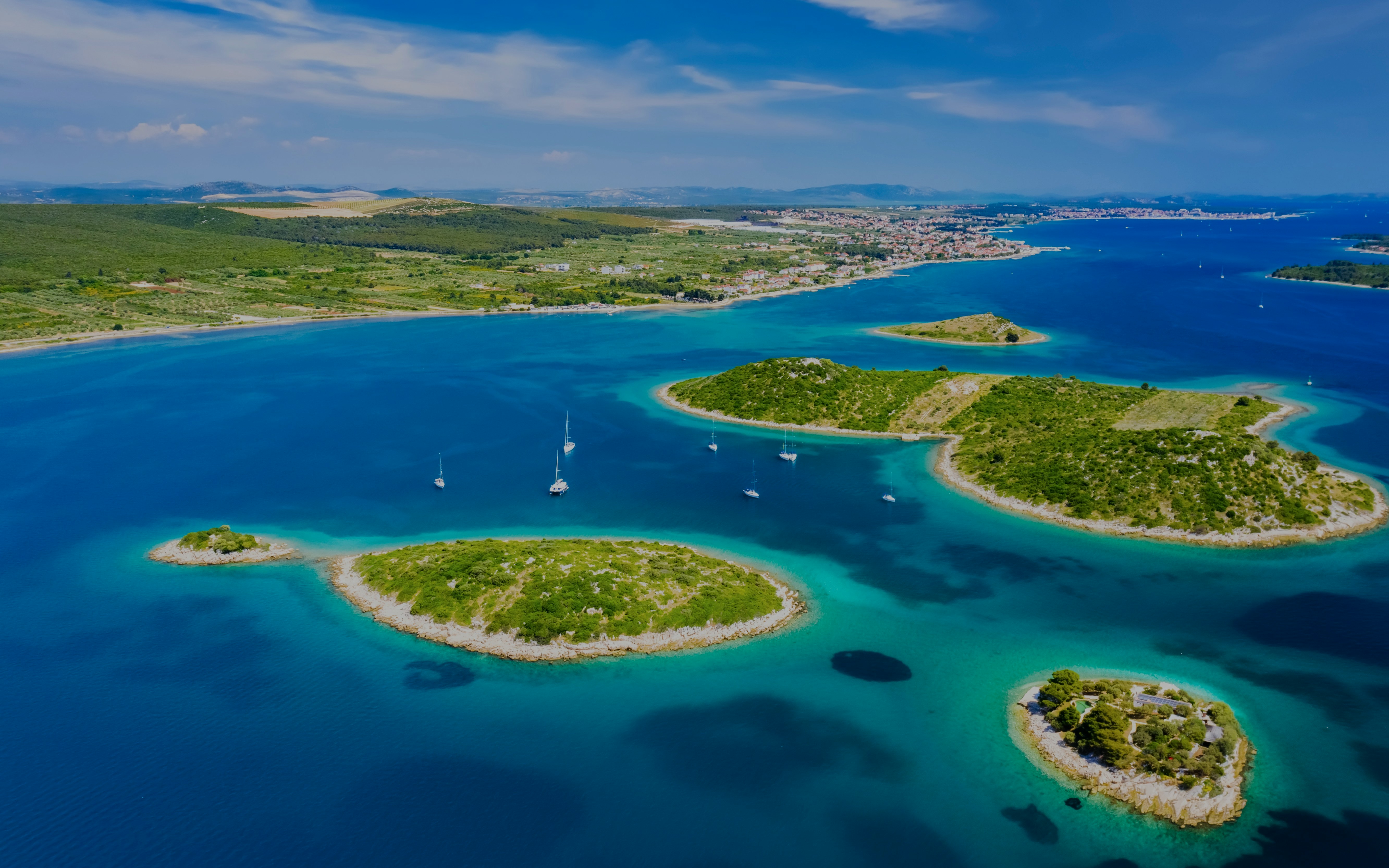 Aerial view of Kornati islands with sailboats at sunrise, Kornati National Park, Croatia.