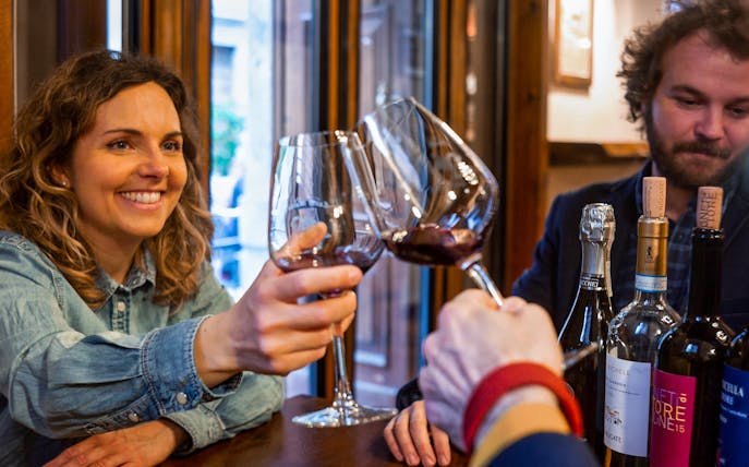 Wine tasting experience near Juliet's Balcony with people toasting glasses.