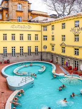 Visitors enjoying the outdoor pool at Lukács Thermal Bath, Budapest.