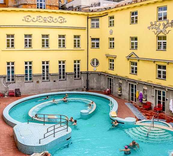 Visitors enjoying the outdoor pool at Lukács Thermal Bath, Budapest.