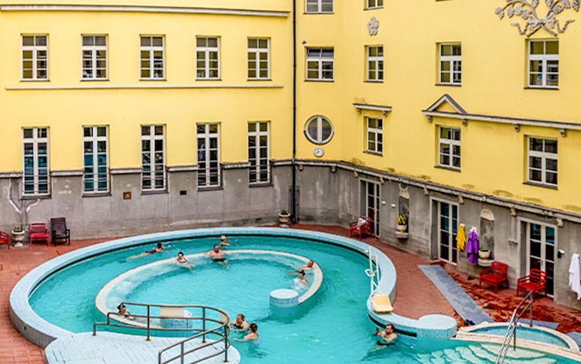 Visitors enjoying the outdoor pool at Lukács Thermal Bath, Budapest.