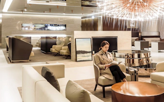 Traveler reading in Matina Gold lounge, Terminal 2, Incheon International Airport.