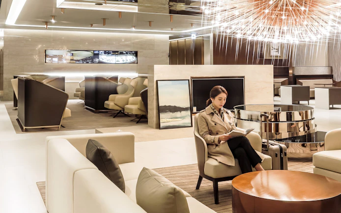 Traveler reading in Matina Gold lounge, Terminal 2, Incheon International Airport.