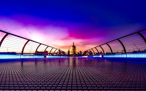 Millennium Bridge leading to St. Paul's Cathedral at sunset, London.