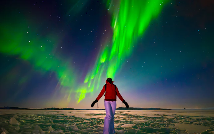 Person viewing Northern Lights during AURORA PRO photography expedition.