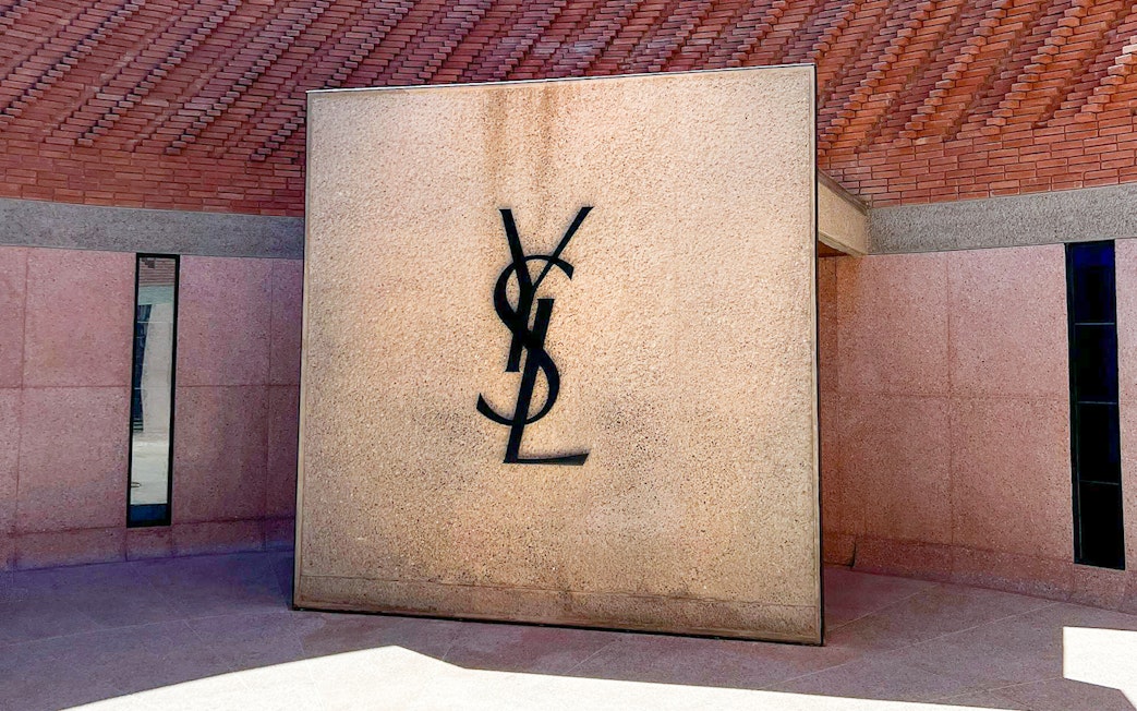 Yves Saint Laurent Museum entrance with YSL logo on stone wall.