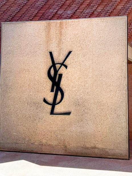 Yves Saint Laurent Museum entrance with YSL logo on stone wall.