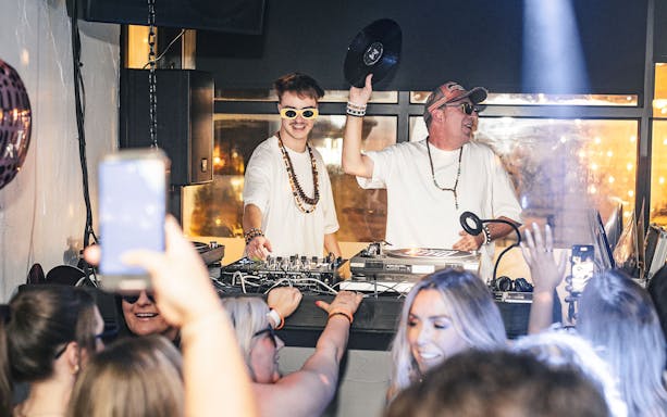 DJs performing at Es Paradis nightclub in Ibiza with a lively crowd on a Tuesday night.