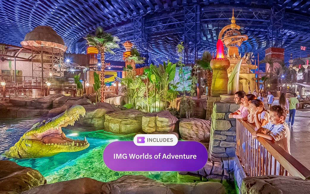 Visitors observing animatronic crocodile at IMG Worlds of Adventure, Dubai indoor theme park.