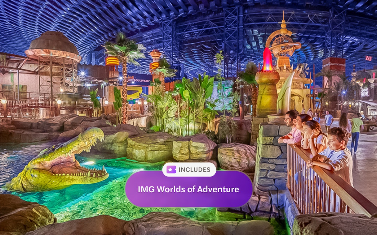 Visitors observing animatronic crocodile at IMG Worlds of Adventure, Dubai indoor theme park.