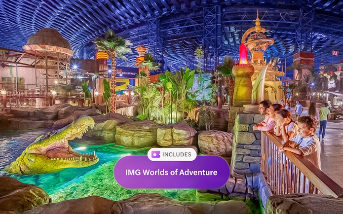 Visitors observing animatronic crocodile at IMG Worlds of Adventure, Dubai indoor theme park.