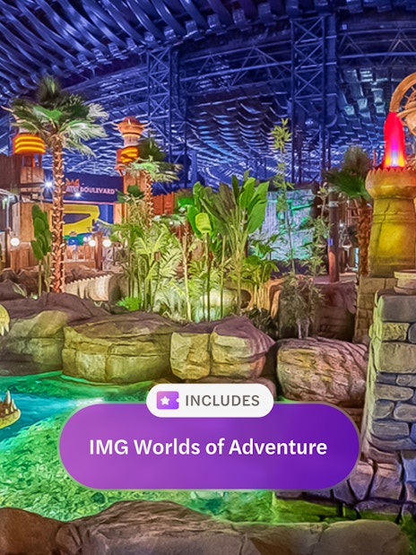 Visitors observing animatronic crocodile at IMG Worlds of Adventure, Dubai indoor theme park.