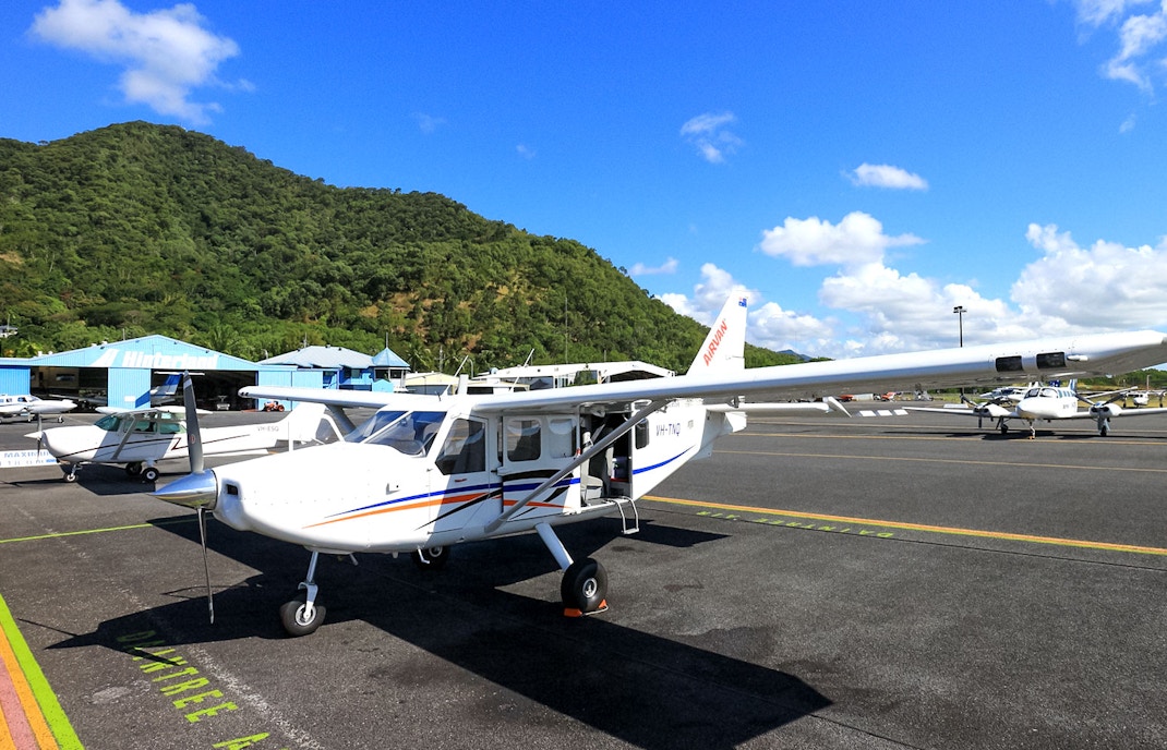 Plane on Cairns airport tarmac before scenic flight to Great Barrier Reef.