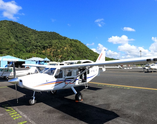 Plane on Cairns airport tarmac before scenic flight to Great Barrier Reef.