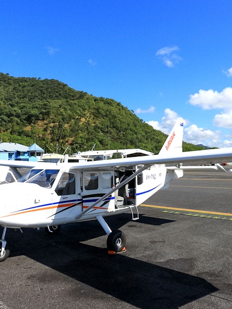 Plane on Cairns airport tarmac before scenic flight to Great Barrier Reef.