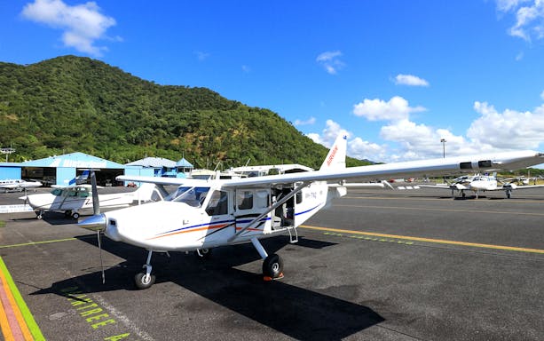 Plane on Cairns airport tarmac before scenic flight to Great Barrier Reef.