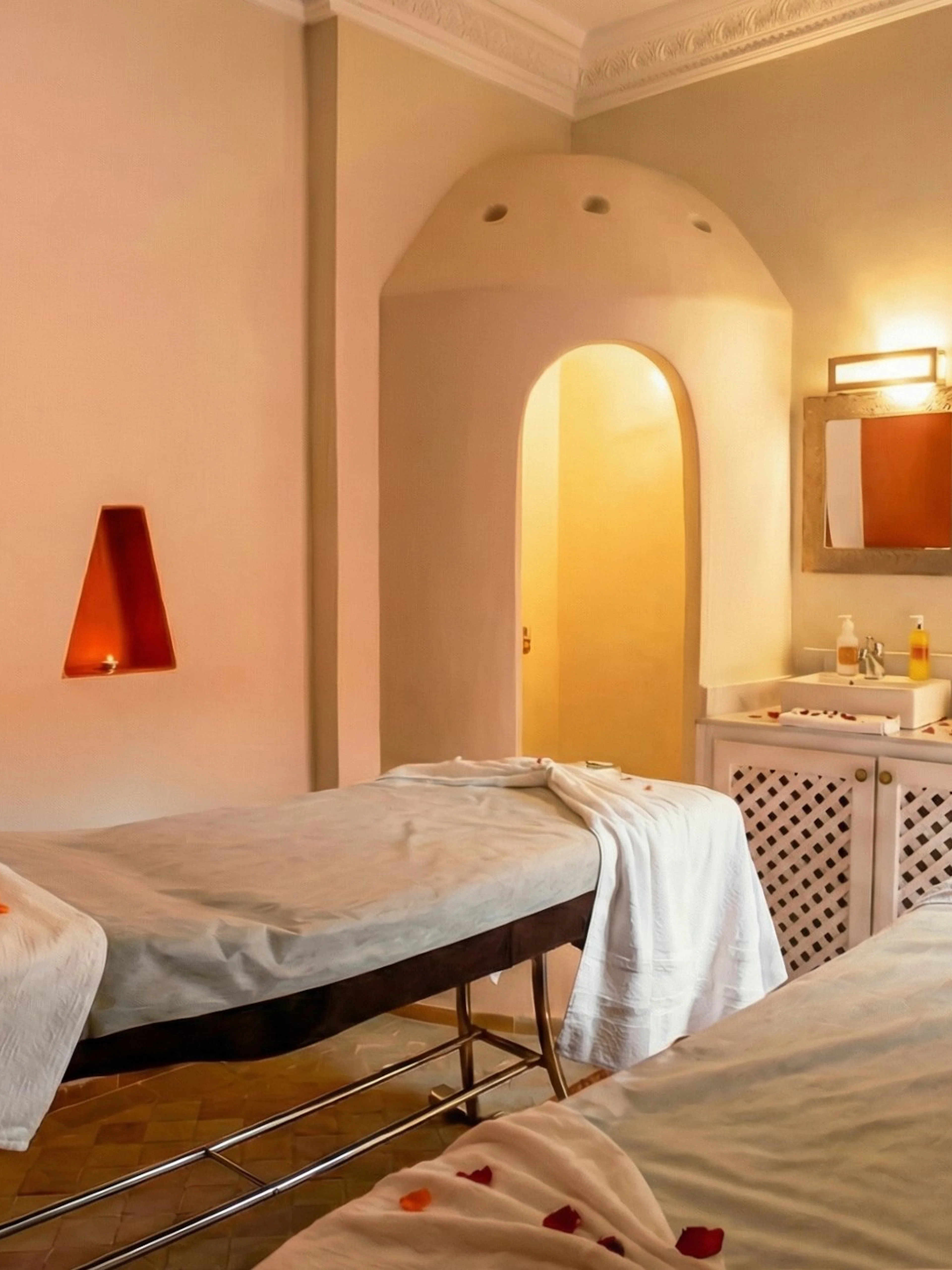 Spa therapy room with massage tables and candles at Moroccan Hammam, Marrakech.