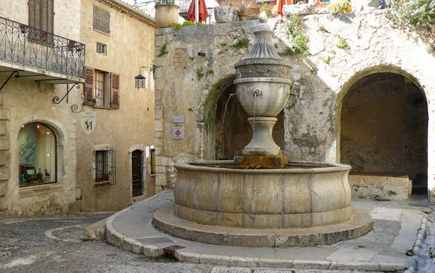 Stone fountain in a quaint street of Saint Paul de Vence, France.