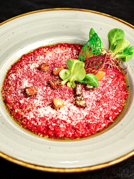 Beetroot risotto garnished with greens on Budapest New Year’s Eve cruise.