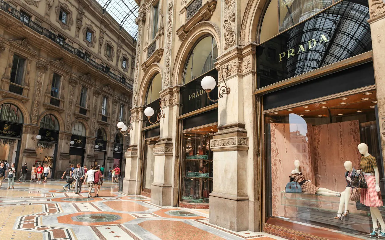 Galleria Vittorio Emanuele II in Milan with Prada storefront and shoppers.