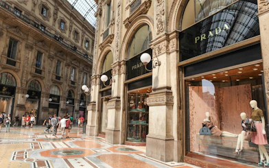Galleria Vittorio Emanuele II in Milan with Prada storefront and shoppers.