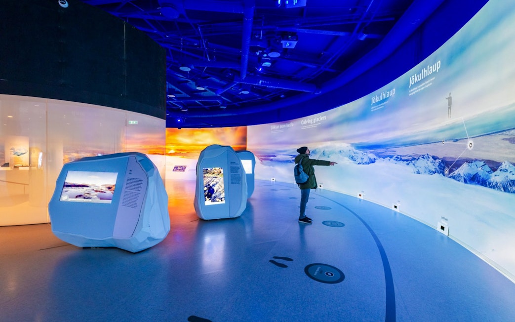 Guests exploring interactive glacier exhibits at Perlan Museum in Reykjavik.