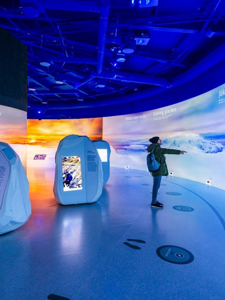 Guests exploring interactive glacier exhibits at Perlan Museum in Reykjavik.