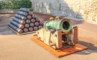 Historic cannon and cannonballs at a fortress in Monte Carlo.