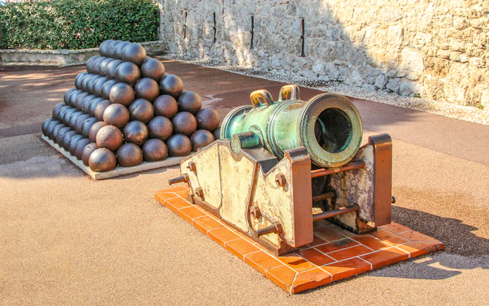 Historic cannon and cannonballs at a fortress in Monte Carlo.