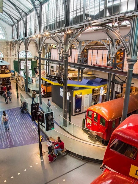 London Transport Museum exhibit with vintage underground train and double-decker buses.