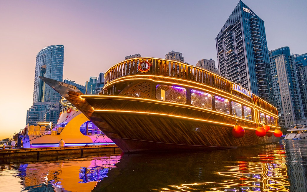 Alexandra Dhow Cruise with lights at Dubai Marina during sunset.