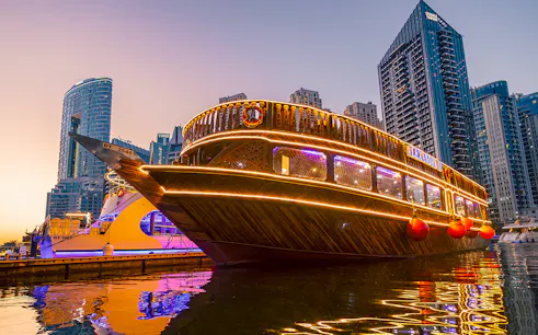 Alexandra Dhow Cruise with lights at Dubai Marina during sunset.