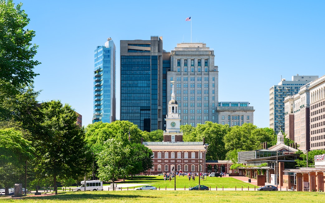 Independence Hall with surrounding modern buildings in Philadelphia.