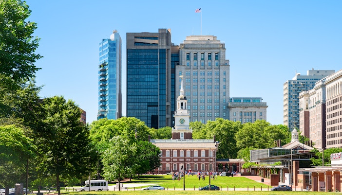 Independence Hall with surrounding modern buildings in Philadelphia.