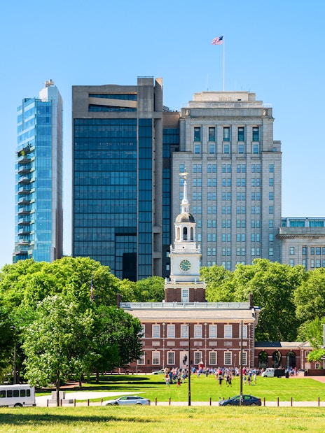 Independence Hall with surrounding modern buildings in Philadelphia.