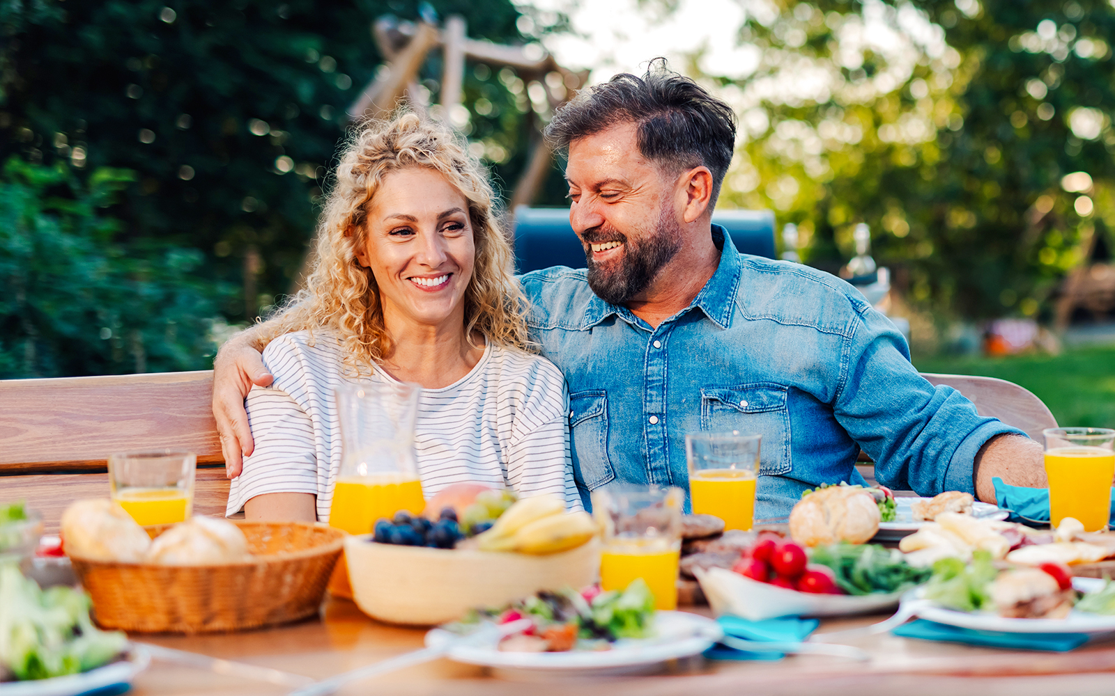 Couple dining at a plant-filled restaurant in a vibrant setting.