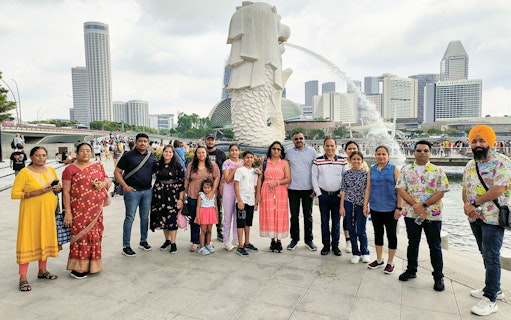 Group at Merlion Park with Singapore skyline, Shared Singapore Attraction Transfers.