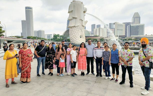 Group at Merlion Park with Singapore skyline, Shared Singapore Attraction Transfers.