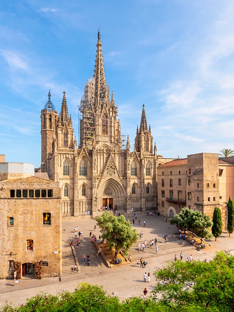 Cathedral of Barcelona exterior with Gothic architecture and surrounding plaza.