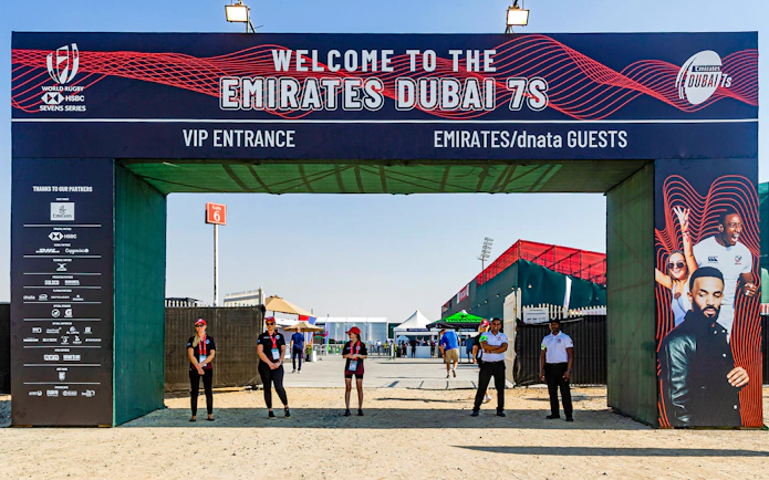Entrance to Emirates Dubai 7s with staff and event signage, Gate 6 in background.